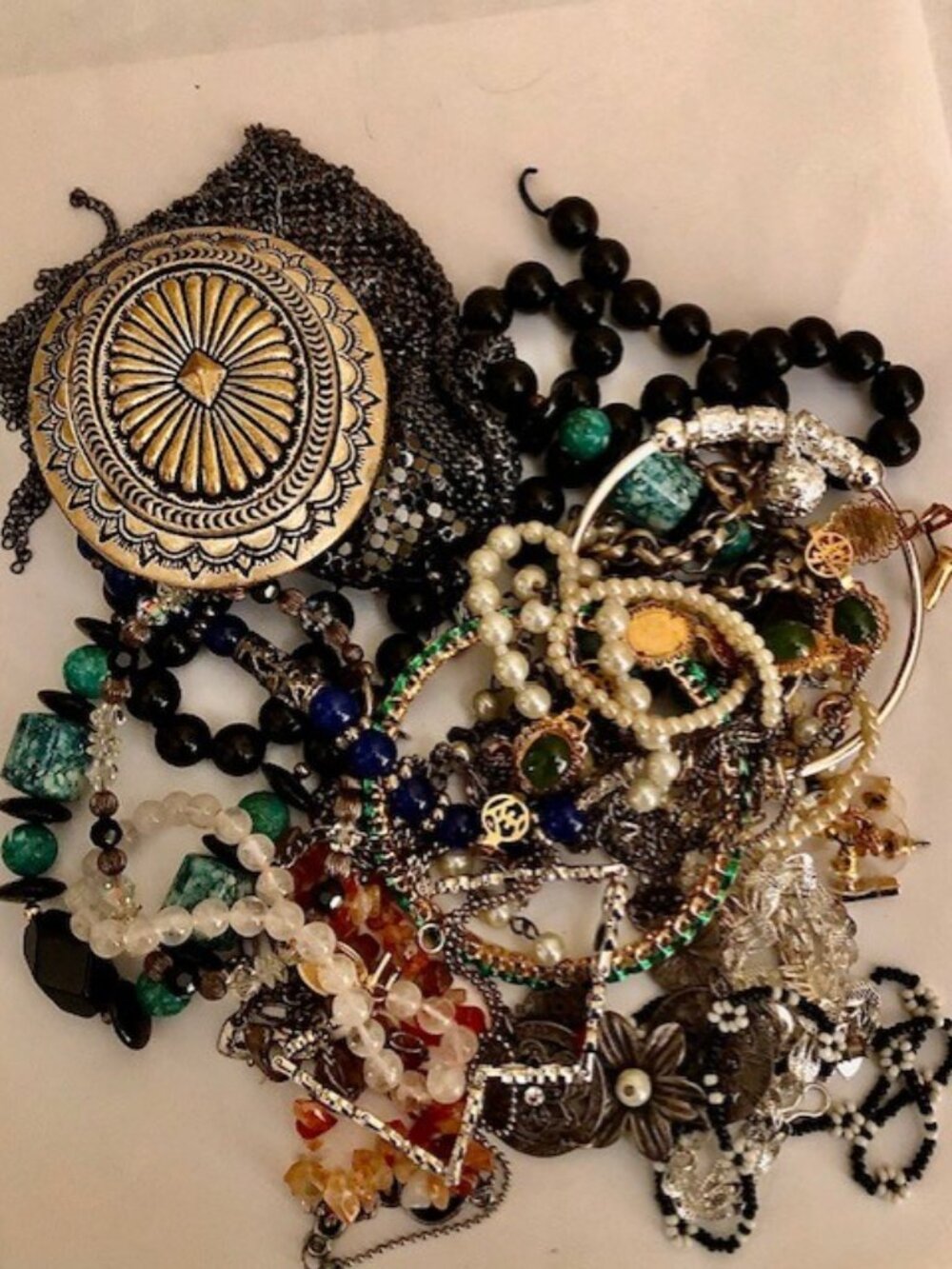 A 22-piece bag of mostly wearable bracelets, earrings, and a concha belt buckle